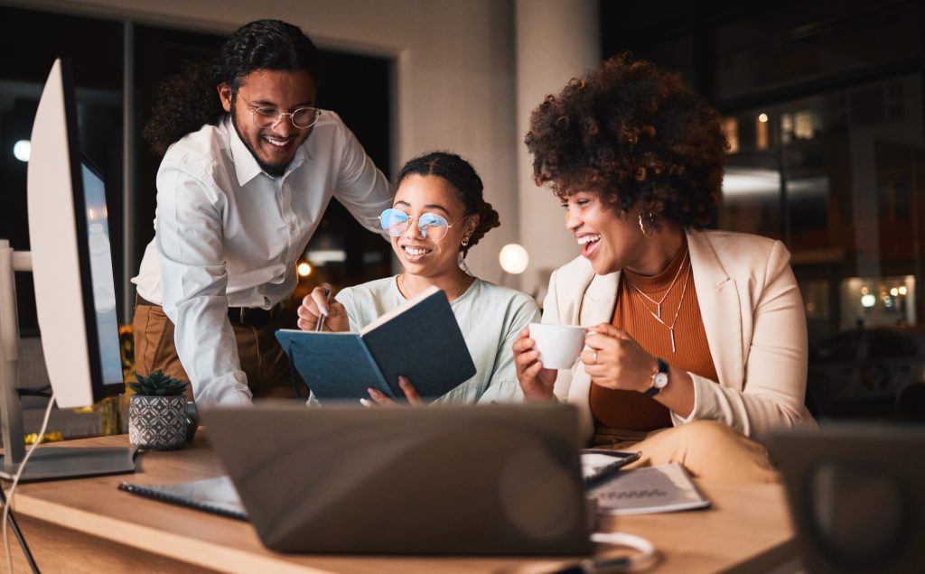 Notebook, planning and business people in discussion at night in the office for a creative website
